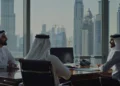 Knowledge workers in UAE and Saudi Arabia using AI agents in a modern office with Gulf skyline in background