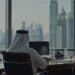 Knowledge workers in UAE and Saudi Arabia using AI agents in a modern office with Gulf skyline in background
